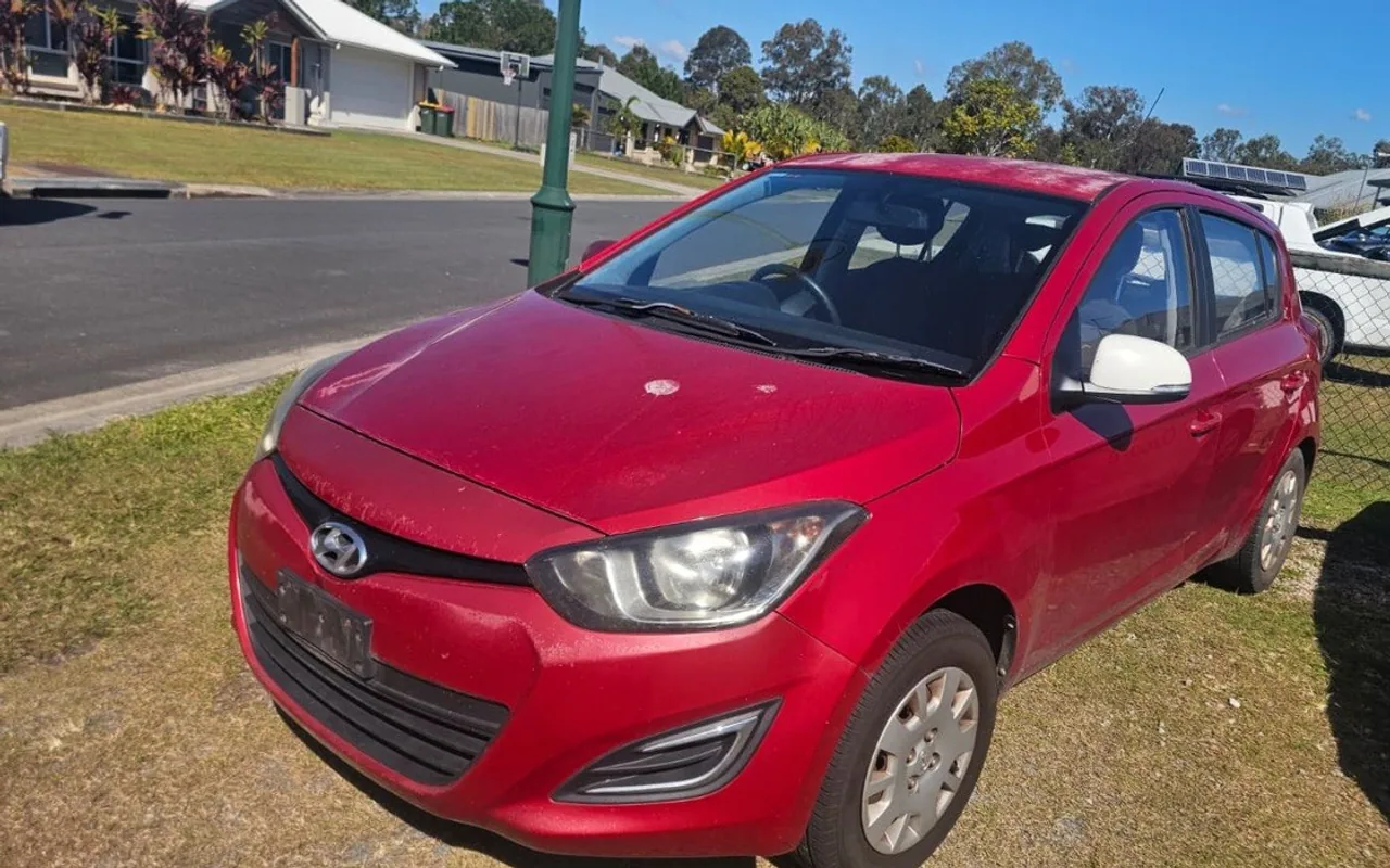 Red Hyundai i20 previously purchased by AK Cash for Cars